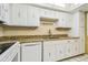 Well-lit kitchen with white cabinets, granite countertops, white appliances, and tiled floor at 17920 Gulf Blvd # 208, Redington Shores, FL 33708