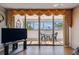Bright living room featuring sliding glass doors that open to a balcony with table and chairs at 17920 Gulf Blvd # 208, Redington Shores, FL 33708