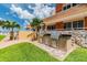 This outdoor grill area features stainless steel appliances set in decorative brick and stone, perfect for entertaining at 17920 Gulf Blvd # 208, Redington Shores, FL 33708