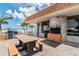 Relax in this outdoor lounge area equipped with comfortable seating and an outdoor grill for social gatherings at 17920 Gulf Blvd # 208, Redington Shores, FL 33708