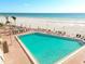 Community outdoor pool with lounge seating and beach views at 17920 Gulf Blvd # 208, Redington Shores, FL 33708