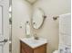 Cozy powder room featuring a classic mirror, neutral walls, and a dark wood vanity at 17920 Gulf Blvd # 208, Redington Shores, FL 33708