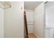 Walk-in closet features white walls, laminate floors, and metal rods for hanging clothes at 17920 Gulf Blvd # 208, Redington Shores, FL 33708