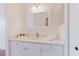 Bright bathroom features a white vanity with a quartz countertop, modern faucet, and a decorative framed mirror at 18107 Peregrines Perch Pl # 6303, Lutz, FL 33558