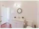 Well lit bathroom with a large countertop and a round decorative mirror at 18107 Peregrines Perch Pl # 6303, Lutz, FL 33558