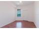 Bright bedroom with hardwood floors and a window overlooking a water view at 18107 Peregrines Perch Pl # 6303, Lutz, FL 33558