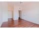 Open bedroom with hardwood floors and a view of a bathroom and closets at 18107 Peregrines Perch Pl # 6303, Lutz, FL 33558