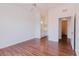 Open bedroom with hardwood floors and a view of a bathroom at 18107 Peregrines Perch Pl # 6303, Lutz, FL 33558