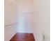 Walk-in closet features wood-look floors and metal shelving for optimal organization and storage solutions at 18107 Peregrines Perch Pl # 6303, Lutz, FL 33558