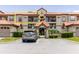 Exterior front of the condos with parking, landscaping, and beautiful tile roof at 18107 Peregrines Perch Pl # 6303, Lutz, FL 33558