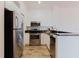 Bright kitchen with stainless appliances and tile backsplash at 18107 Peregrines Perch Pl # 6303, Lutz, FL 33558