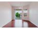 Bright living room with beautiful wood floors and sliding glass doors to balcony at 18107 Peregrines Perch Pl # 6303, Lutz, FL 33558