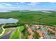 Beautiful aerial view of a golf course community showcasing lush greenery and a scenic lake at 1905 Oyster Catcher Ln # 924, Clearwater, FL 33762
