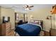 Comfortable bedroom featuring a ceiling fan, TV, and desk workspace at 1905 Oyster Catcher Ln # 924, Clearwater, FL 33762