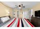 Bright bedroom features a ceiling fan, closet, and attached bathroom at 1905 Oyster Catcher Ln # 924, Clearwater, FL 33762