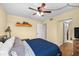 Bedroom with ceiling fan, wood floors, and ensuite bathroom access at 1905 Oyster Catcher Ln # 924, Clearwater, FL 33762