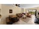 Living room featuring a ceiling fan, fireplace, comfortable seating, and sliding glass doors at 1905 Oyster Catcher Ln # 924, Clearwater, FL 33762