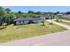 Aerial view of a home with a lush green lawn and separate garage at 20295 Lorenzo Ave, Port Charlotte, FL 33952