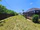 Large backyard with a privacy fence and screened-in lanai, perfect for outdoor living at 20295 Lorenzo Ave, Port Charlotte, FL 33952