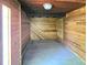 Basement space featuring wood paneling and tile flooring with a view of an adjacent room with natural light at 20295 Lorenzo Ave, Port Charlotte, FL 33952