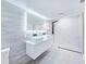 Bathroom featuring a modern vanity with double sinks, LED mirror, walk-in shower with black fixtures at 20295 Lorenzo Ave, Port Charlotte, FL 33952
