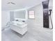 Bathroom featuring a modern vanity with double sinks, LED mirror, and shower system with black fixtures at 20295 Lorenzo Ave, Port Charlotte, FL 33952