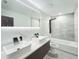 Modern bathroom featuring dual sinks, LED mirror, walk in shower and tub at 20295 Lorenzo Ave, Port Charlotte, FL 33952