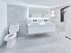 Modern bathroom features gray tile, double sink vanity, black faucet, and walk in shower at 20295 Lorenzo Ave, Port Charlotte, FL 33952