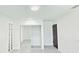Bright bedroom with tile floor, glass block window, mirrored closet, and dark wood door at 20295 Lorenzo Ave, Port Charlotte, FL 33952