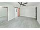 Bright bedroom with a sliding mirror closet door and a rustic wood accent door at 20295 Lorenzo Ave, Port Charlotte, FL 33952