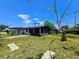 Desirable home with a screened in lanai, lush landscaping, and a well maintained lawn at 20295 Lorenzo Ave, Port Charlotte, FL 33952