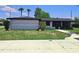 Charming single-story home featuring a modern exterior, manicured lawn, and inviting walkway at 20295 Lorenzo Ave, Port Charlotte, FL 33952