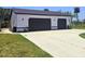 Spacious detached garage with two bays, plenty of parking, and a well-maintained lawn at 20295 Lorenzo Ave, Port Charlotte, FL 33952
