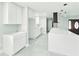 Well-lit kitchen showcasing a modern island with white countertops, sleek cabinetry and dark range hood at 20295 Lorenzo Ave, Port Charlotte, FL 33952