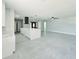 Open-concept living area with sleek tile flooring, island and modern fixtures at 20295 Lorenzo Ave, Port Charlotte, FL 33952