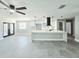Spacious living room with tiled flooring, an island, and modern finishes at 20295 Lorenzo Ave, Port Charlotte, FL 33952