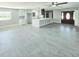 Large living room featuring tiled floors, an island, and views of the front door at 20295 Lorenzo Ave, Port Charlotte, FL 33952