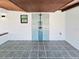 Outdoor shower with artistic tile design, with gray flooring and tongue and groove ceilings at 20295 Lorenzo Ave, Port Charlotte, FL 33952