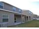 Backyard showcasing a covered patio and expansive green space, perfect for outdoor living at 20420 Carolina Cherry Ct, Tampa, FL 33647