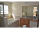 Bright bathroom with a soaking tub, granite vanity, and separate shower for a relaxing home spa experience at 20420 Carolina Cherry Ct, Tampa, FL 33647