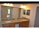 Bathroom featuring double sinks, granite counters, and mirrors at 20420 Carolina Cherry Ct, Tampa, FL 33647