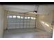 Clean, empty garage with ample space and garage door at 20420 Carolina Cherry Ct, Tampa, FL 33647
