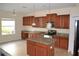 Well-lit kitchen showcasing ample cabinet space, granite countertops, and a center island at 20420 Carolina Cherry Ct, Tampa, FL 33647
