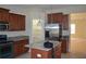 Modern kitchen featuring stainless steel appliances, granite countertops, and a large pantry at 20420 Carolina Cherry Ct, Tampa, FL 33647