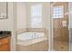 Bright bathroom with soaking tub under window and separate glass shower at 215 S Westland Ave # 3, Tampa, FL 33606