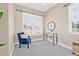 Inviting bedroom with cozy blue accent chair, a large sunny window, and neutral decor at 215 S Westland Ave # 3, Tampa, FL 33606
