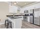 Modern kitchen featuring stainless steel appliances, granite countertops, and ample cabinet space at 215 S Westland Ave # 3, Tampa, FL 33606