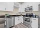Bright kitchen features stainless steel appliances, white cabinetry, dark countertops, and modern fixtures at 215 S Westland Ave # 3, Tampa, FL 33606