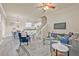 Open-concept living room showcasing modern gray floors, a ceiling fan, and views into the kitchen and dining area at 215 S Westland Ave # 3, Tampa, FL 33606