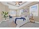 Bright main bedroom featuring a tray ceiling, neutral walls, a ceiling fan, and large windows at 215 S Westland Ave # 3, Tampa, FL 33606